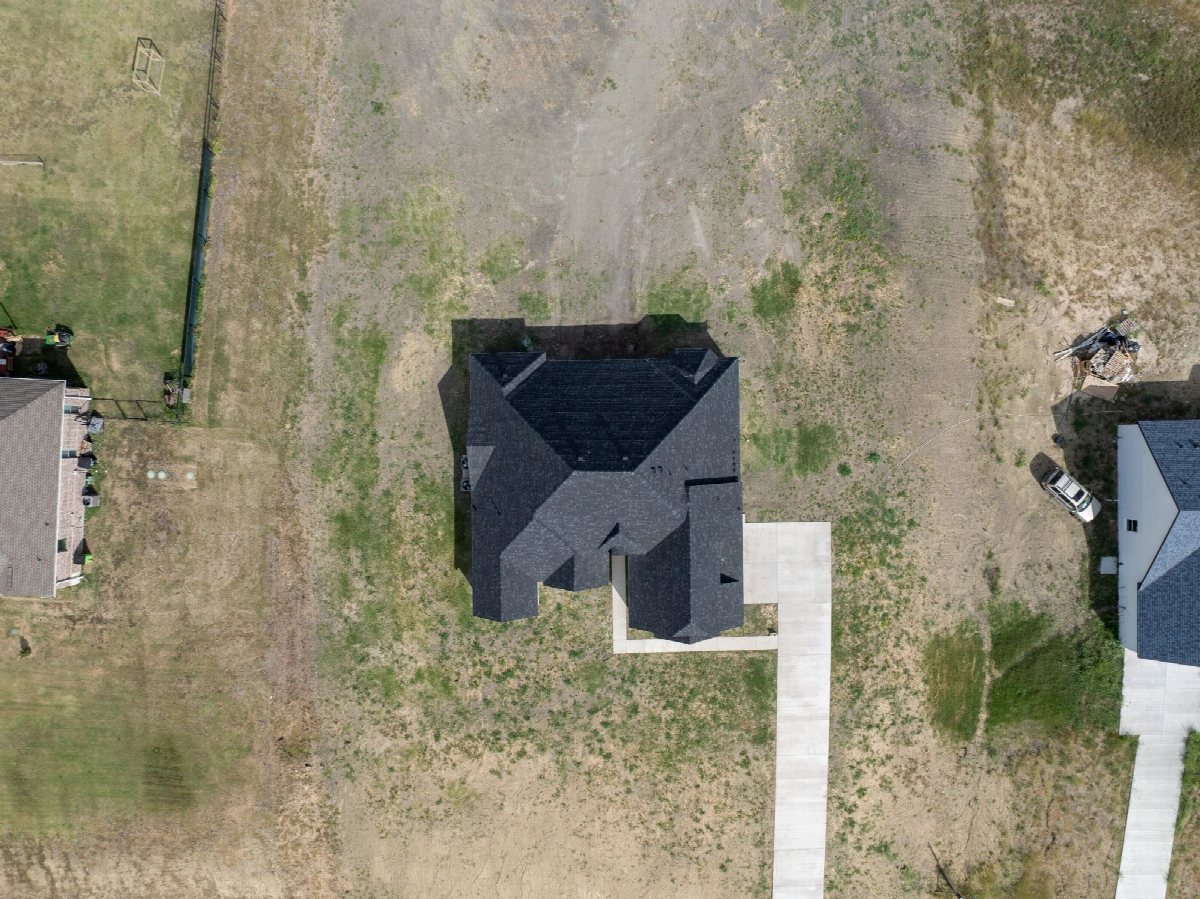 Overhead aerial photograph of a house roof and driveway.